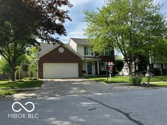 534 Austrian Way, Avon, IN 46123 - traditional home with an attached garage, brick siding, and concrete driveway