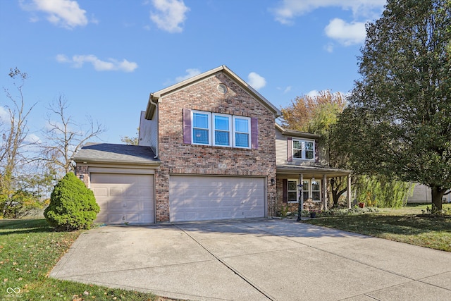 view of front property featuring a garage and a front yard