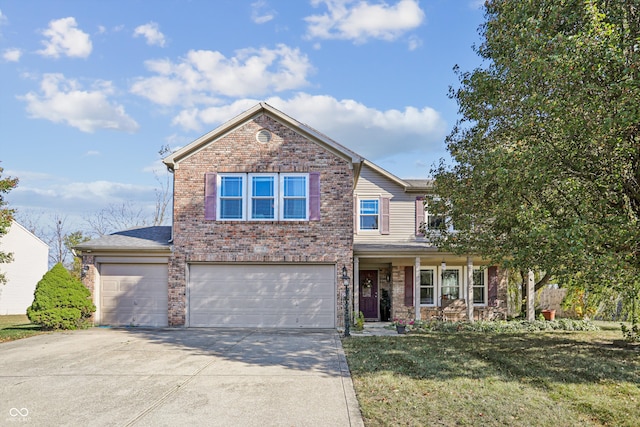 view of property featuring a garage and a front lawn