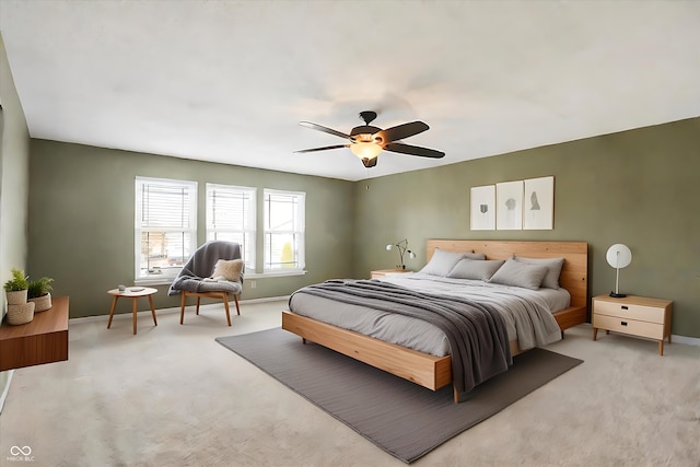 bedroom with light colored carpet and ceiling fan