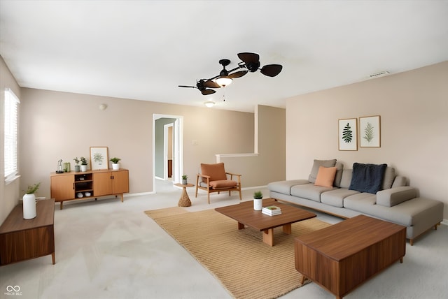 living room featuring ceiling fan and light colored carpet