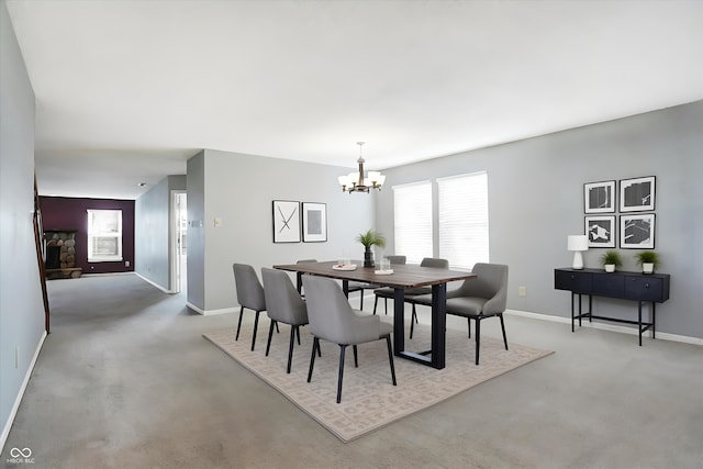 carpeted dining area featuring an inviting chandelier