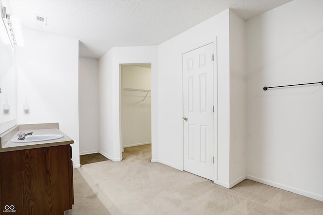 bathroom with a textured ceiling and vanity