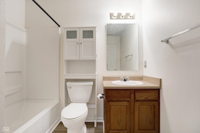 full bathroom with hardwood / wood-style flooring, vanity, shower / bath combination, and toilet