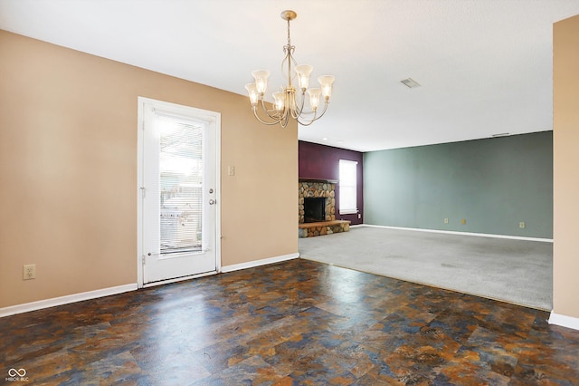 interior space featuring an inviting chandelier and a stone fireplace