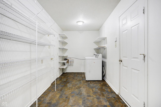 laundry room with washer / dryer and a textured ceiling