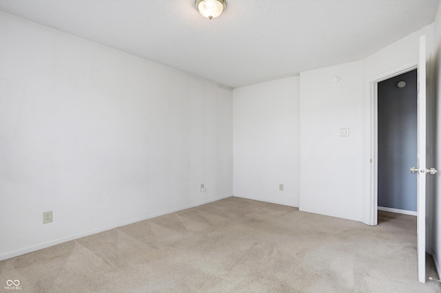 spare room with light colored carpet