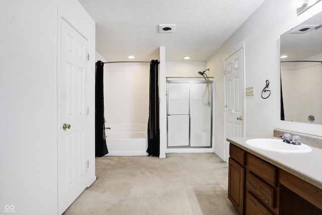 bathroom featuring vanity, a textured ceiling, and walk in shower