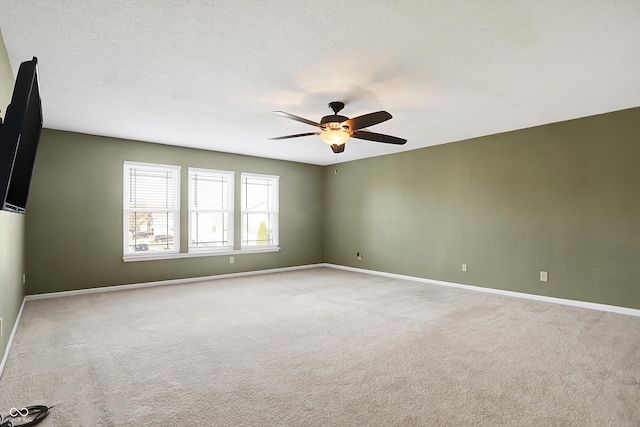 carpeted empty room featuring a textured ceiling and ceiling fan