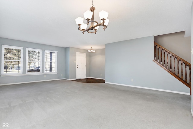 unfurnished living room featuring carpet floors and a chandelier