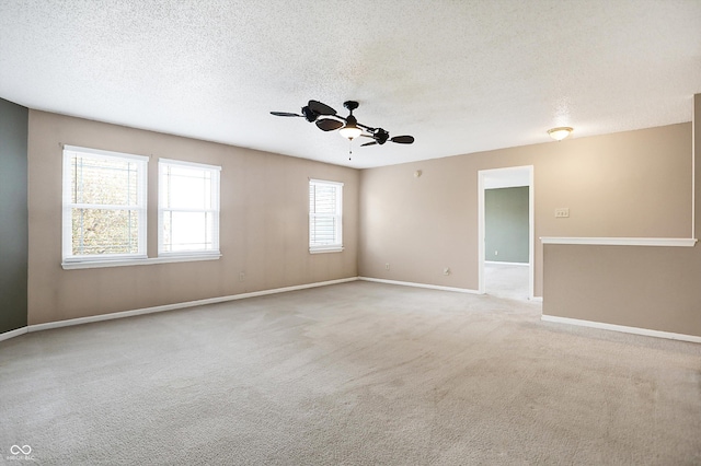 carpeted empty room with a textured ceiling and ceiling fan