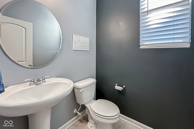 bathroom featuring sink, toilet, and tile patterned floors