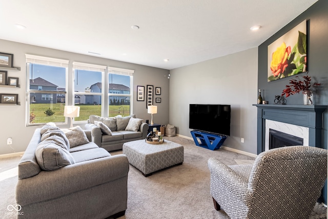 living room with light colored carpet and a high end fireplace