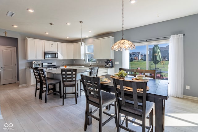 dining space featuring light hardwood / wood-style floors