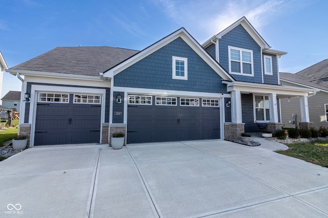 craftsman-style house featuring a porch and a garage