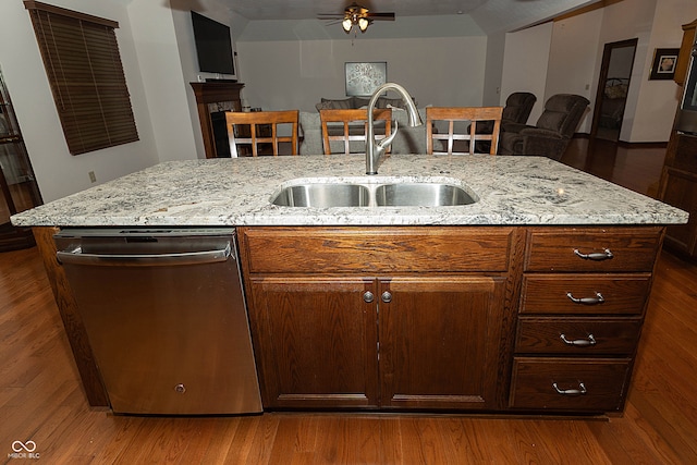 kitchen featuring dishwasher, dark hardwood / wood-style flooring, sink, and an island with sink