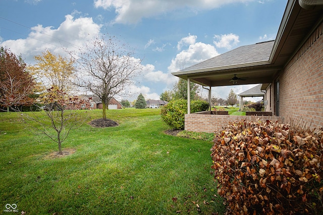 view of yard with ceiling fan