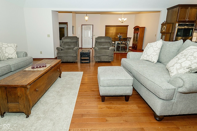 living room with a notable chandelier and hardwood / wood-style flooring