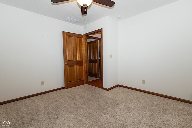 spare room with carpet, a textured ceiling, and ceiling fan