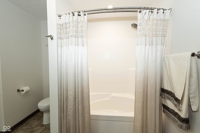 bathroom with shower / bath combo, a textured ceiling, and toilet