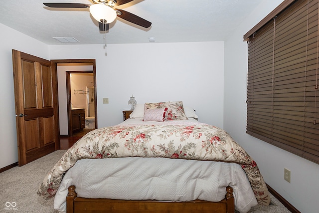 carpeted bedroom with ceiling fan and connected bathroom