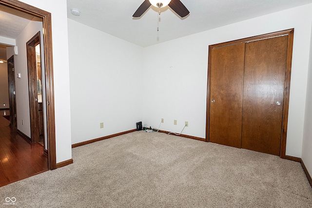 unfurnished bedroom featuring wood-type flooring, ceiling fan, and a closet