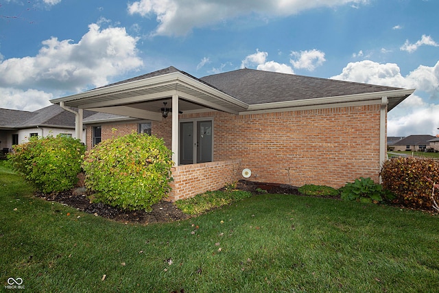 rear view of property featuring a yard