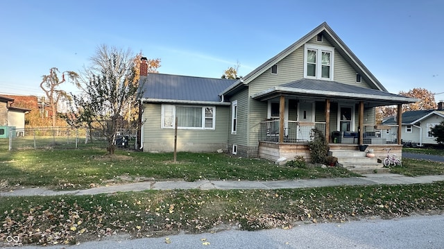 bungalow-style house featuring a porch and a front lawn