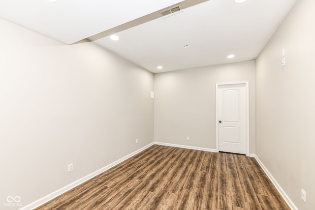 spare room featuring dark wood-type flooring