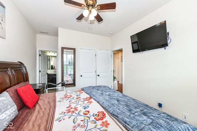 bedroom featuring ceiling fan and ensuite bath