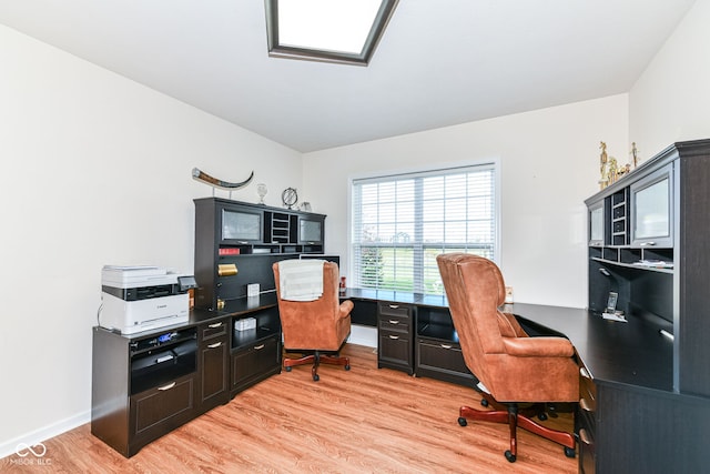 home office with light hardwood / wood-style floors