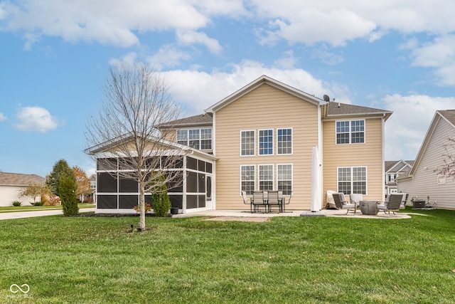 rear view of house with a sunroom, central AC unit, a yard, and a patio