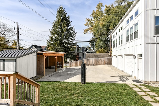 view of yard featuring a shed and a patio area