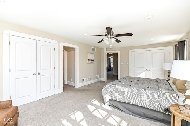 carpeted bedroom featuring ceiling fan and a closet