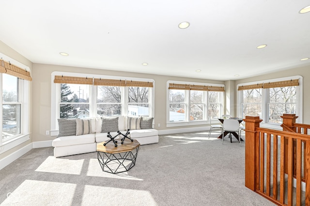 living room with plenty of natural light and light colored carpet