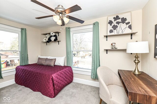 bedroom featuring light carpet and ceiling fan