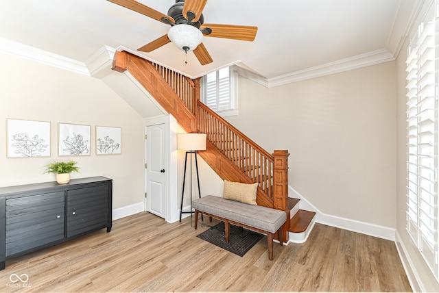 sitting room featuring light wood-type flooring, ceiling fan, and ornamental molding