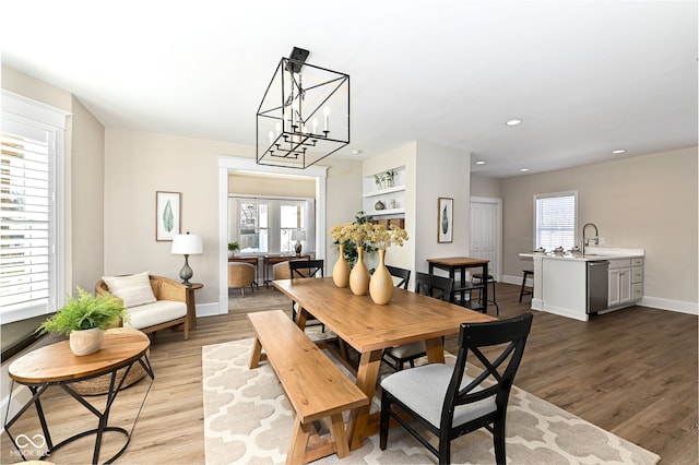 dining space with sink and light hardwood / wood-style flooring