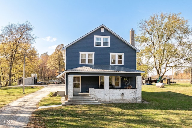 rear view of property with a lawn, a playground, and a porch