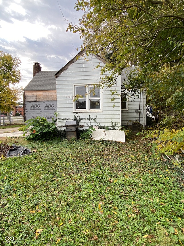 view of home's exterior with a yard