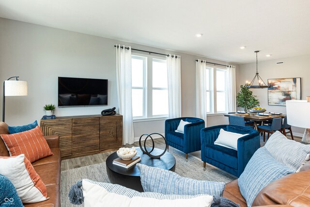 living room featuring light hardwood / wood-style floors and a chandelier