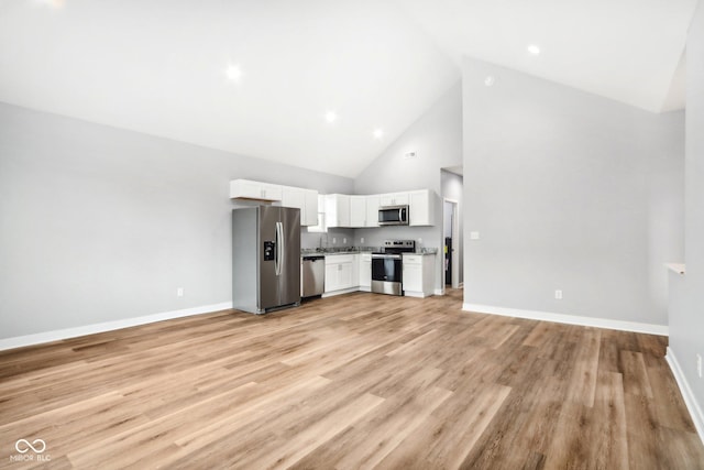 unfurnished living room featuring light hardwood / wood-style flooring and high vaulted ceiling