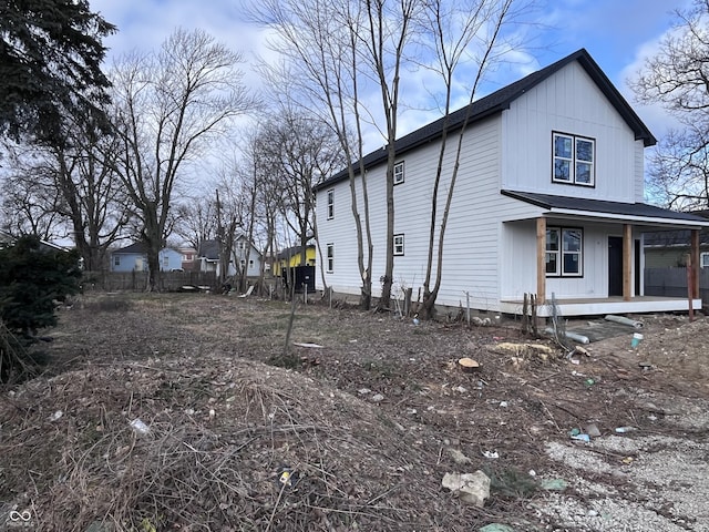 view of side of property featuring covered porch