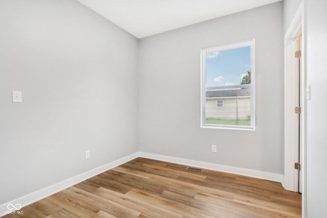 spare room with light hardwood / wood-style floors and a wealth of natural light