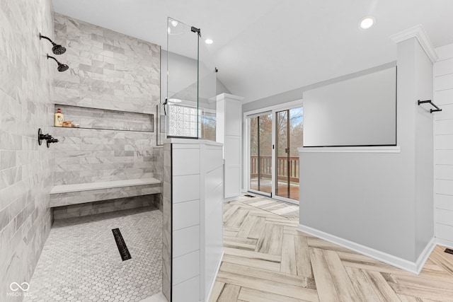 bathroom featuring lofted ceiling, tiled shower, and parquet floors