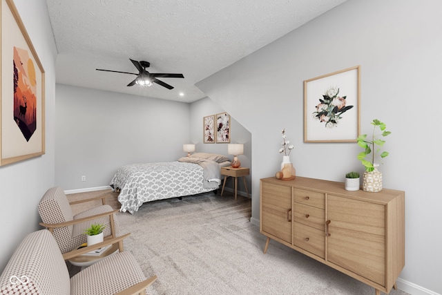 carpeted bedroom featuring ceiling fan and a textured ceiling