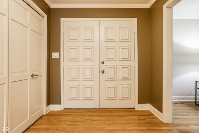 interior space with crown molding and light hardwood / wood-style floors