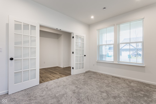 unfurnished room with french doors and carpet