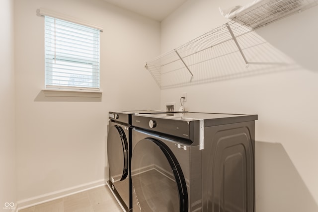 laundry area with washing machine and clothes dryer