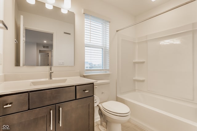 full bathroom featuring a wealth of natural light, vanity, bathing tub / shower combination, and toilet